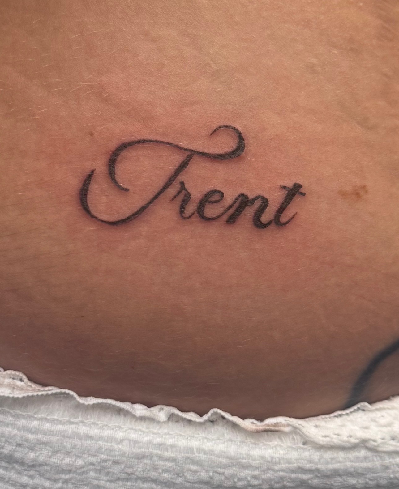 Name tattoo in script before laser treatment